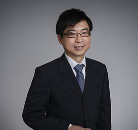 Asian man with glasses smiling